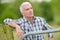 Outdoorsman leaning on fence