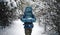 Outdoorsman walking on forest path