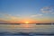 The outfall on sand beach. Beautiful sunrise sky over sea