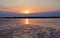 The outfall on sand beach. Beautiful sunrise sky over sea