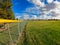 Outfield fence at a baseball field on a cloudy day