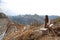 Outfit of casual woman. Brunette sitting on bench enjoying nature above mountains view landscape. Travel Lifestyle adventure