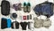 Outfit of traveler, climger, student, teenager. Overhead of essentials for modern sport young person. Different objects on wooden