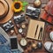 Outfits and accessories of traveler on wooden background