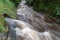 The outflow leading to the regulated river. Rapid river in a mountain area