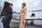 Outgoing businesswoman welcoming with pilot