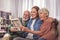Outgoing pensioners and daughter watching at picture