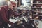 Outgoing retiree cleaning motorcycle in mechanic shop