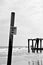 Outline of pier against rough seas Danger Keep Away sign