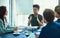 Outlining new ideas in the boardroom. Shot of a young executive talking during a meeting with colleagues in a boardoom.