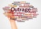 Outrage word cloud and hand with marker concept