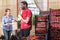 Outraged female farmer and confused worker talking in greenhouse vegetable store