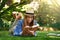 Outside with her favourite book. an attractive young woman reading a book while lying outside on the grass.