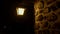 Outside lantern on the old stone house at night over dark sky