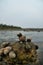 Outside nature photo featuring many little snails on a rock in a tide pool