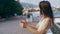 Outside portrait of Beautiful young sexy woman in white bikini standing on bay at seaside, against a blue sea.