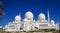 Outside view of the marble domes and the minaret of Sheikh Zayed Mosque in Abu Dhabi