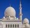 Outside view of the marble domes and the minaret of Sheikh Zayed Mosque in Abu Dhabi