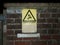 Outside yellow danger of death warning sign wall