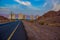 Outskirts car road to Eilat Israeli city urban country side view with sand stone rocks foreground and living buildings background