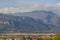 Outskirts suburb village valley foreground and foggy mountain ridge background landscape