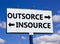 Outsource or insource symbol. Concept word Outsource or Insource on beautiful billboard with two arrows. Beautiful blue sky with