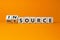 Outsource or insource symbol. Fliped wooden cubes and changed the word `outsource` to `insource`. Beautiful orange background,