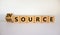 Outsource or insource symbol. Fliped wooden cubes and changed the word `outsource` to `insource`. Beautiful white background,