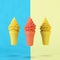 Outstanding orange ice-cream cone among yellow ice-cream cone on pastel blue and yellow background