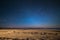 Outstanding starry sky at high altitude on the barren highlands of the Andes in Bolivia. Football ground soccer field in the mid