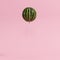 Outstanding watermelon floating like balloon on pastel pink background for copy space