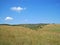 OUTSTRECHED GRASSLAND IN AFRICA WITH HILLS IN THE BACKGROUND