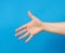 Outstretched hand of man, open hand, part of the body on a blue background