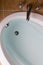 Oval bathtub full of clean water ready for a bath