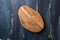 Oval cutting board on blue wooden background