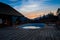 Oval open-air swimming pool high in the mountains against the backdrop of the beautiful summer sunset and mountains. The