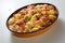 Oval pan with potato casserole with cheese and bacon