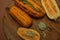 Oval pumpkin lies on a wooden table