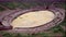 Oval-shaped Amphitheater surrounded by a Mediterranean Hill