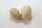 Oval-shaped chicken eggs are deformed, compared to normal eggs on white background.
