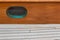 Oval ships porthole window by the deck of a sailboat, screen and verdigris patina, creative copy space