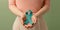 Ovarian and Cervical Cancer Awareness. Woman Holding Teal Ribbon on Lower Abdomen, Uterus, Female Reproductive System