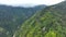 OVARO MIONE, ITALY - APRIL, 2023: Aerial drone view of a valley in the morning with clouds. Small mauntain village Mione