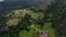 OVARO MIONE, ITALY - APRIL, 2023: Aerial drone view of a valley in the morning with clouds. Small mauntain village Mione