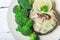 Oven-cooked Wild Black Cod steak Served with Broccoli, parsley and lemon. Light white wooden background, top view