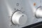 Oven cooking temperature control knob. Kitchen equipment panel detail