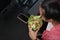 Over head shot of woman overweight having fresh salad at lunch.