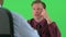 over the shoulder of two businessmen talking on greenscreen