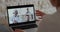 Over shoulder view of female nurse talking with doctors videoconferencing