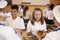 Over shoulder view of kids being served in school cafeteria